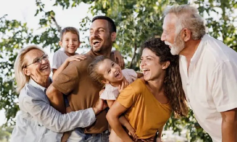 A joyful multigenerational family enjoying time outdoors together.
